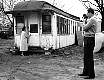 man taking photo of an old passenger train 1957