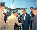 president johnson 1962 shaking hands with a general at an airport width=