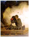 soldier looking thru binoculars - explosions in background