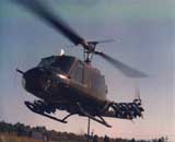 close up of a helicoptor in flight with missiles