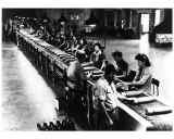 Black and white image of people working on a assembly line