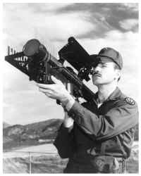 Photo of a soldier aiming a STINGER surface-to-air missile weapon system, a personal portable shoulder-fired infrared homing surface-to-air missile.