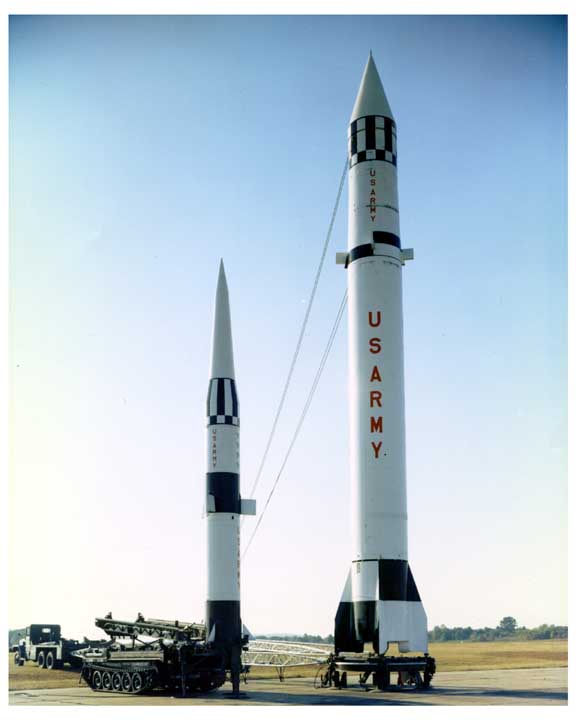 Photo of a Pershing missile beside a Redstone rocket.