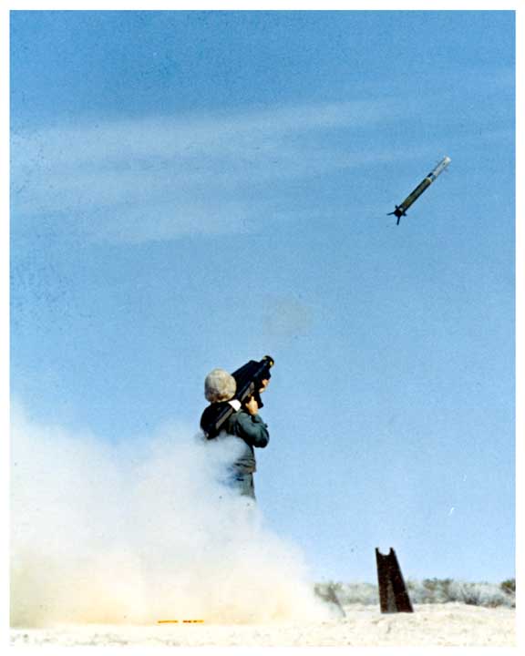 Photo of a soldier firing a REDEYE missile, with flight of missile captured in flight.