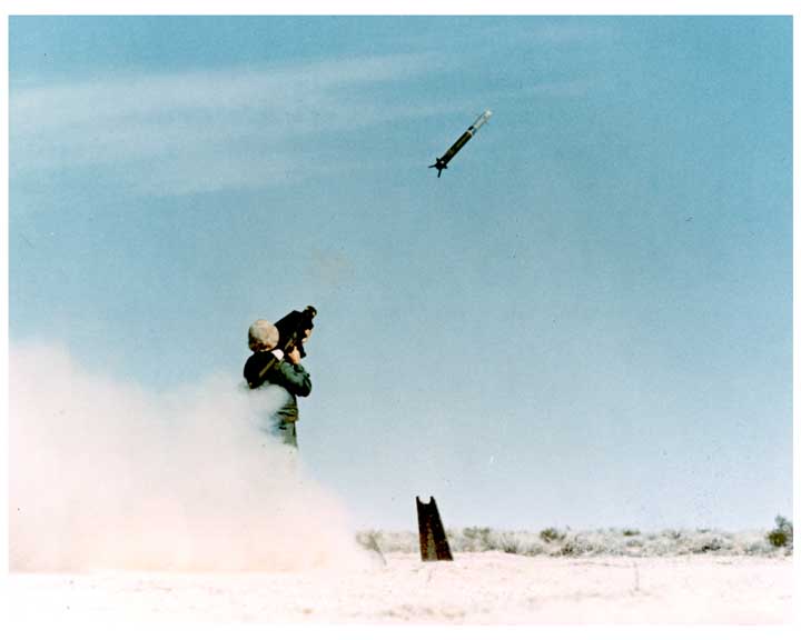 Photo of a soldier firing a REDEYE missile, with flight of missile captured in flight.