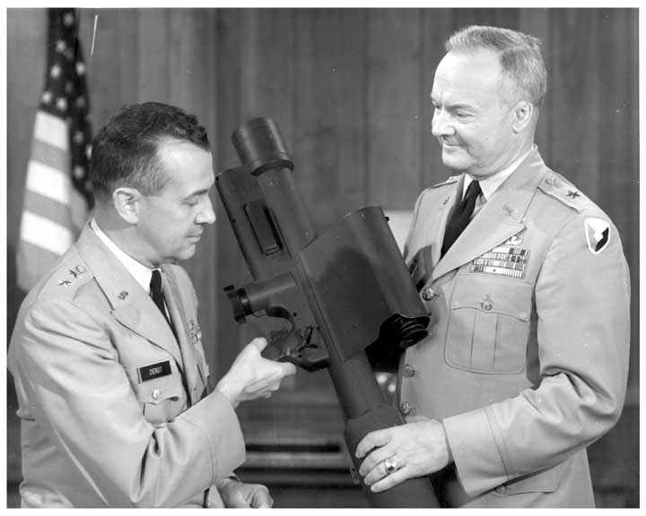 Photo dated June 1964 of Army Major General John Zierdt being shown a REDEYE a missile launcher by an unidentified Army brigadier general.  Both generals are in dress uniform.