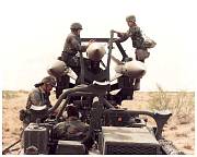 4 soldiers riding on a hawk missile mobile unit