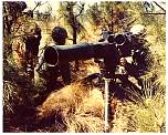 Photo of 3 soldiers employing a ground mounted TOW missile.